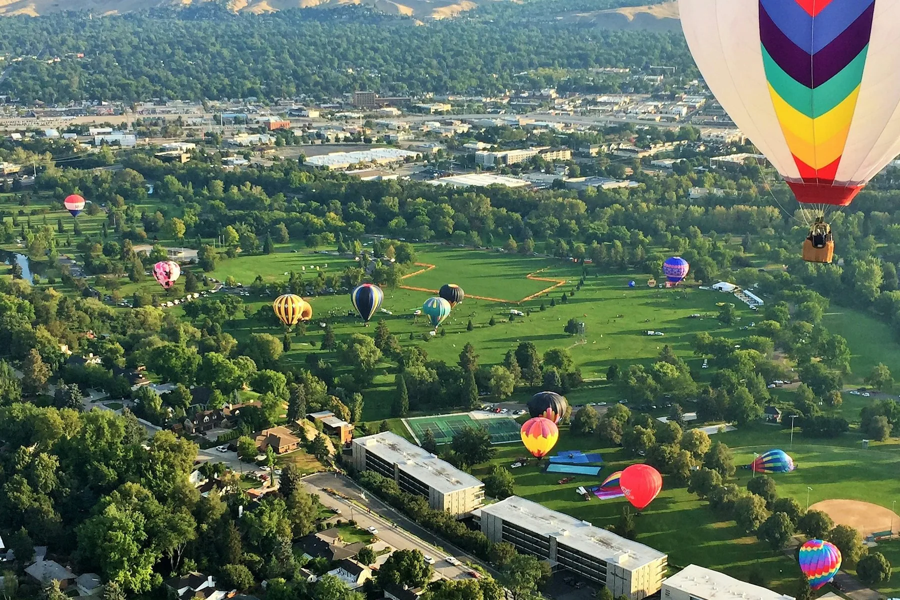 Aerial view of the Boise valley with hot air balloons — the Treasure Valley and foothills beyond