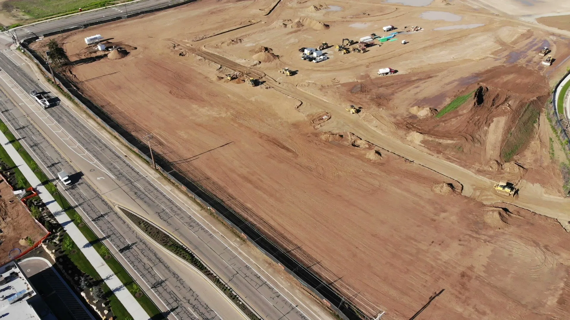 April 22, 2026 drone overview of the full 36-acre Discovery Meridian site with grading complete and foundations beginning