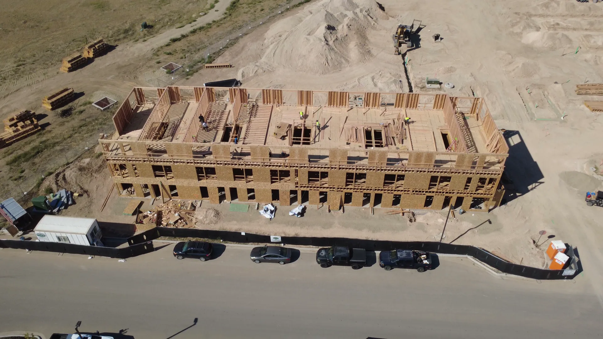 Close aerial detail of the Arête townhome wood framing in September 2026, showing the roofline and unit walls taking shape