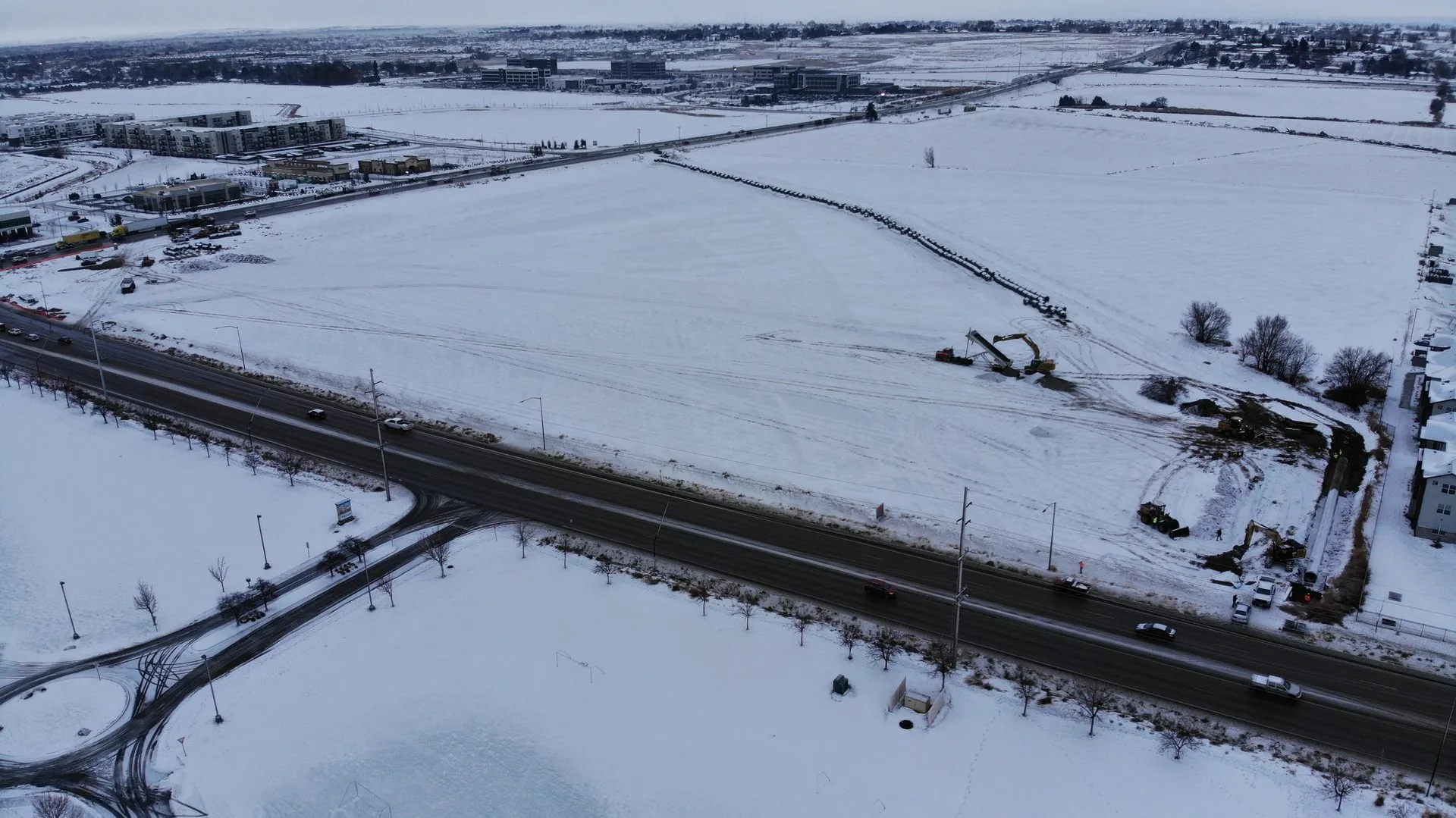 Aerial view of the site in January 2022, blanketed in snow with the canal cut running through the property